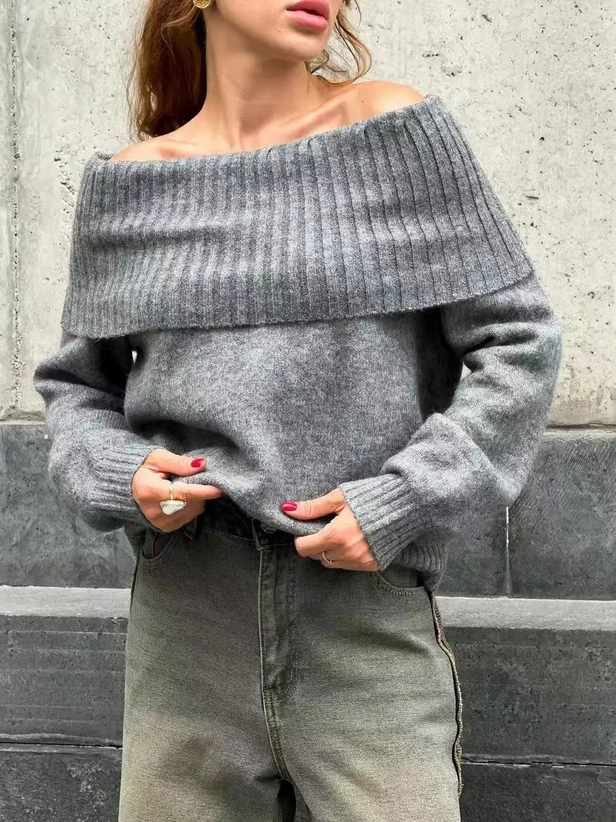 Woman wearing a grey off-the-shoulder sweater with a raised 3D texture pattern.