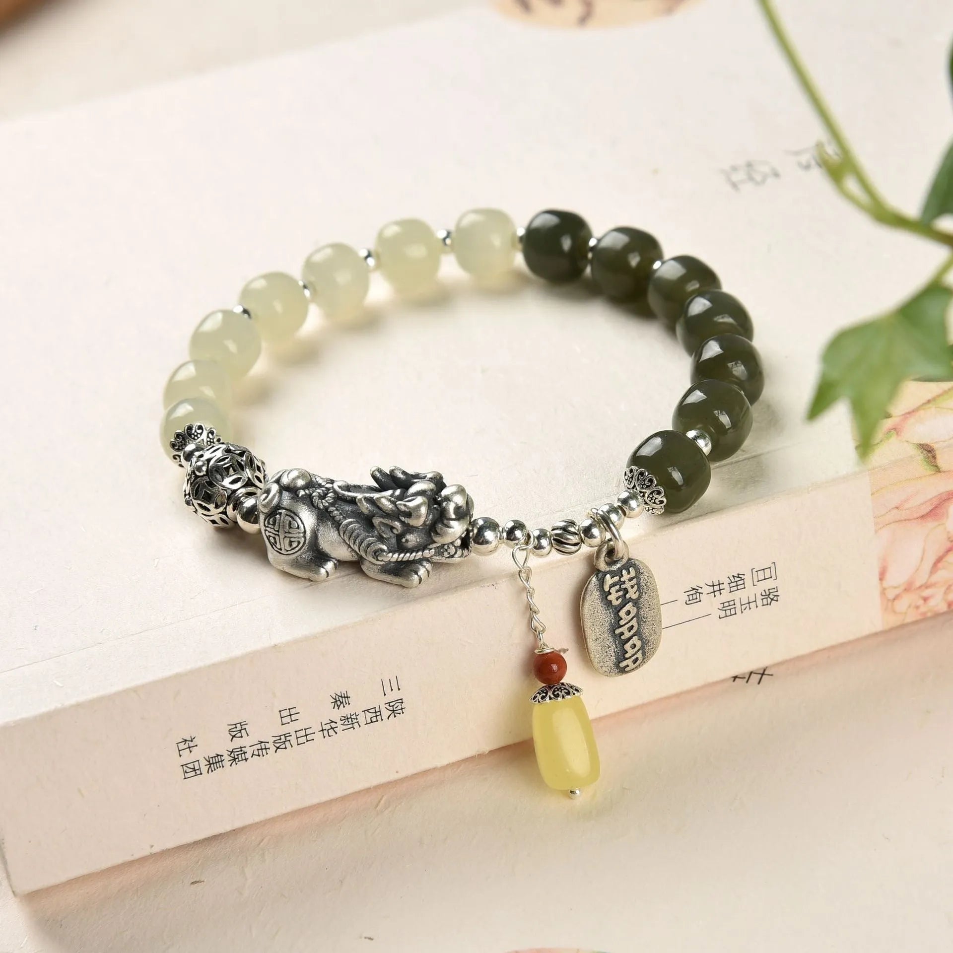 Retro women's silver coin bracelet with a natural Hetian jade stone.