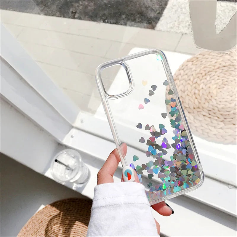 Quicksand flowing love heart silicone phone case in transparent soft TPU bumper for iPhone, available in pink red silver.