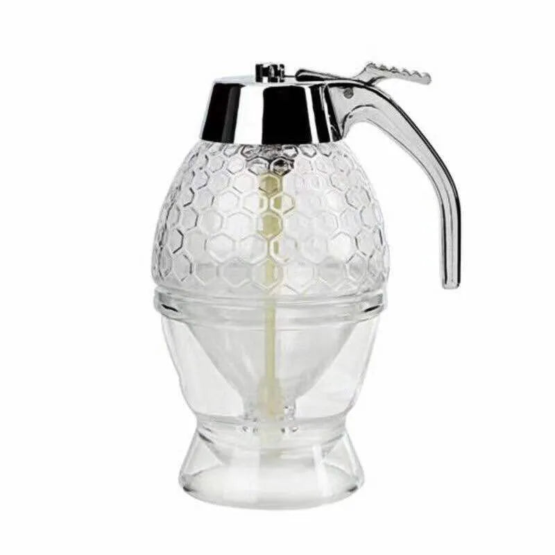 Transparent squeezable honey jar dispenser with 200ml capacity and bee design, sitting on a kitchen counter