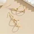Gold geometric spiral earrings with ellipse elements and electroplated finish