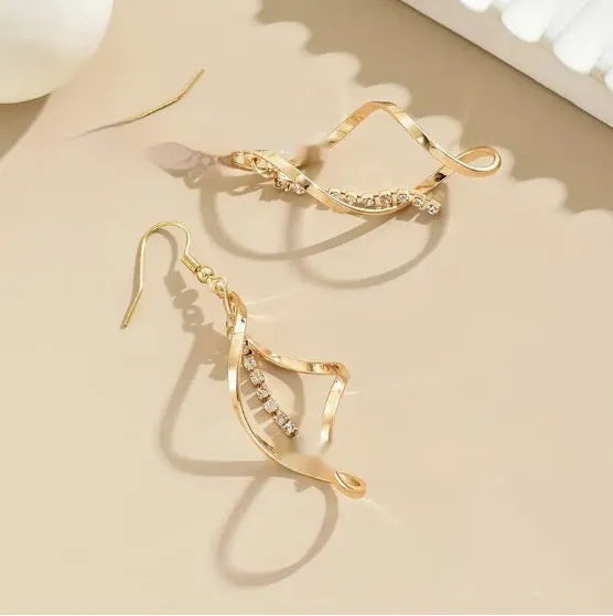Gold geometric spiral earrings with ellipse elements and electroplated finish