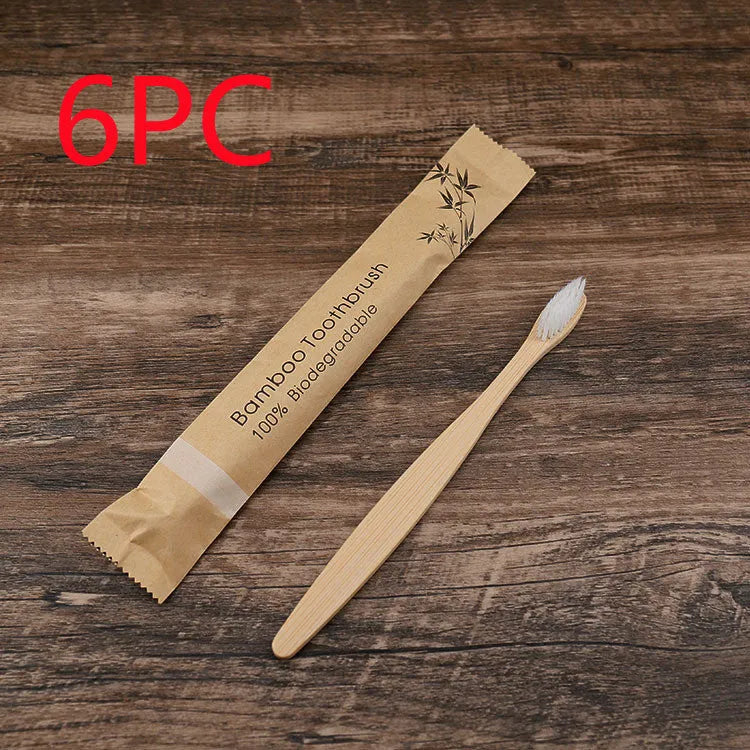 10 multi-coloured natural bamboo toothbrushes with soft charcoal bristles arranged on a white background