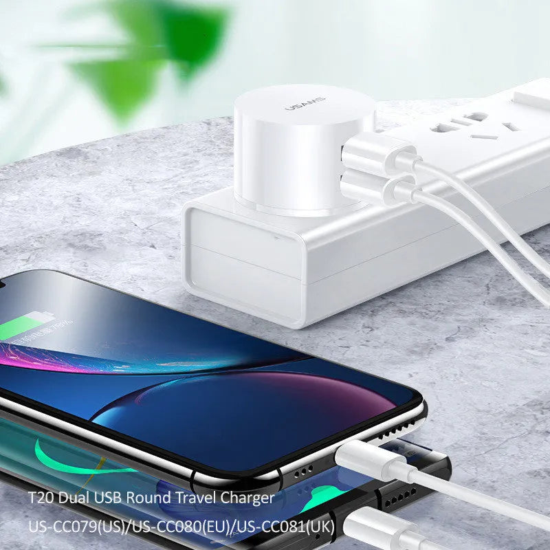 White dual USB phone charger with international plugs for US EU UK regions showing compact 39mm diameter design