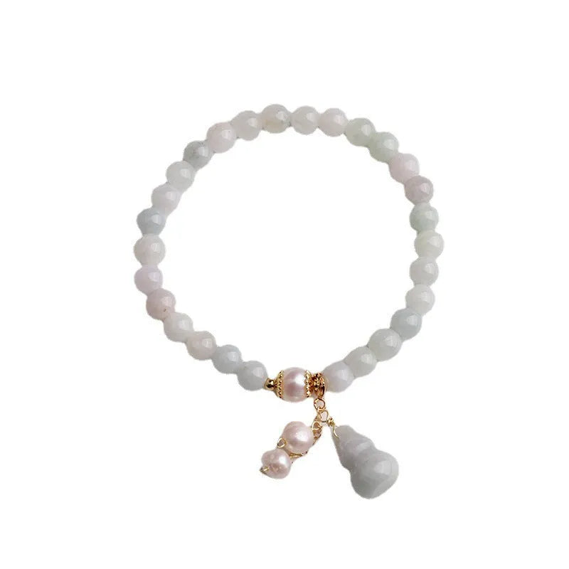 Chinese style women's jade bracelet with traditional gourd design featuring emerald jade insets and pearl elements