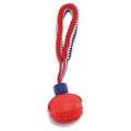 Blue and red natural rubber dog ball with attached rope for tug-of-war and teeth cleaning