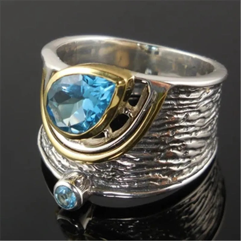 Blue zircon Chinese style women's ring with inlaid design showing drop shape silhouette