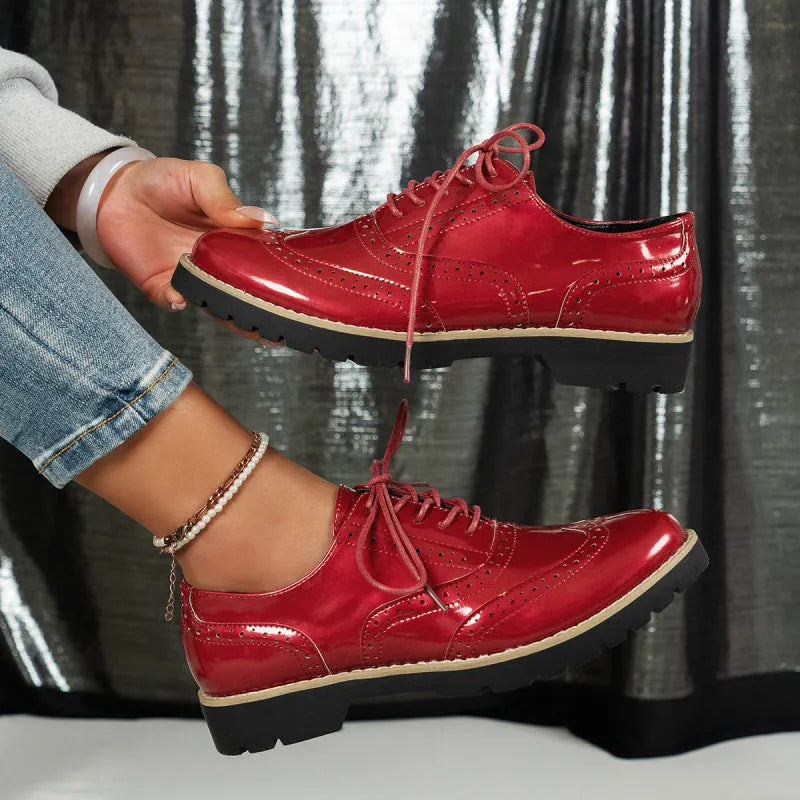Women's black lace-up Oxford loafers with a wedge heel and sequin detail on the upper.