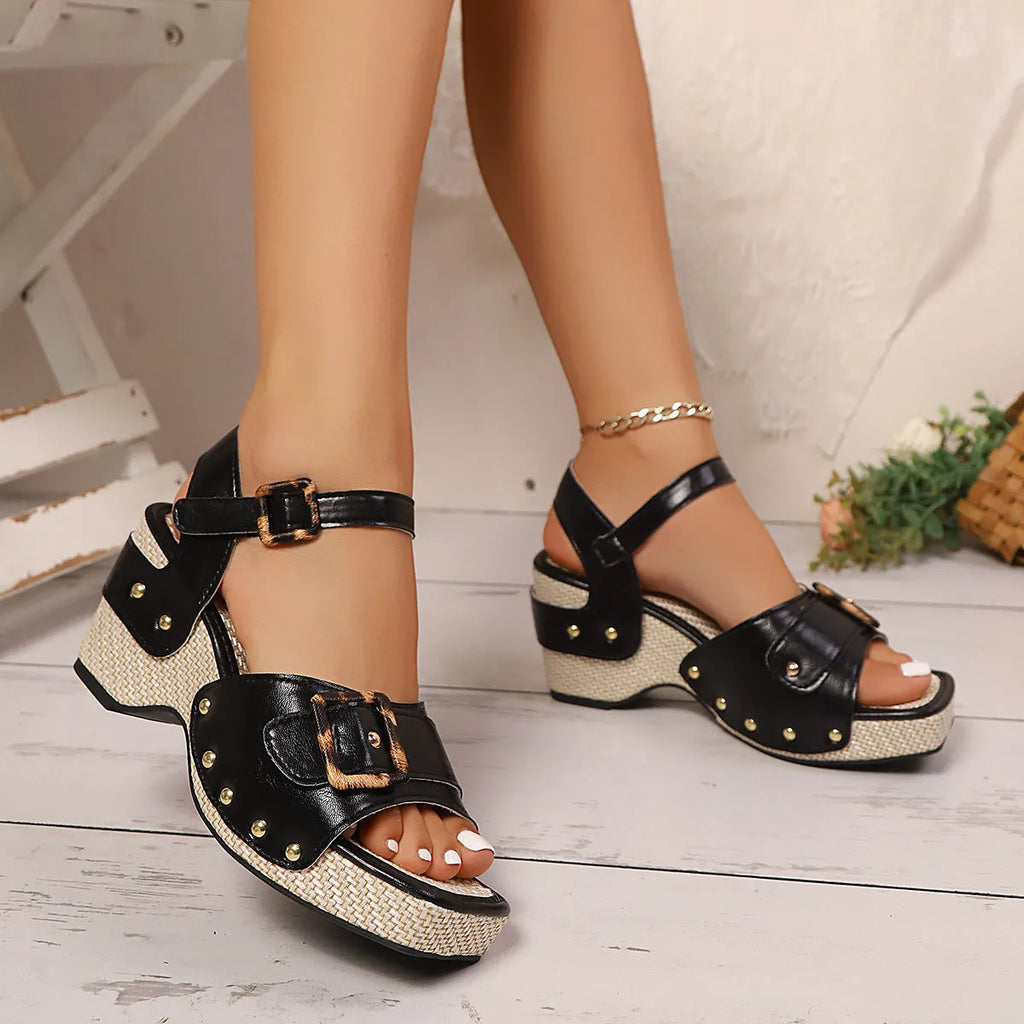 White women's chunky heel sandals with a square toe and large metal buckle fastening on the strap.