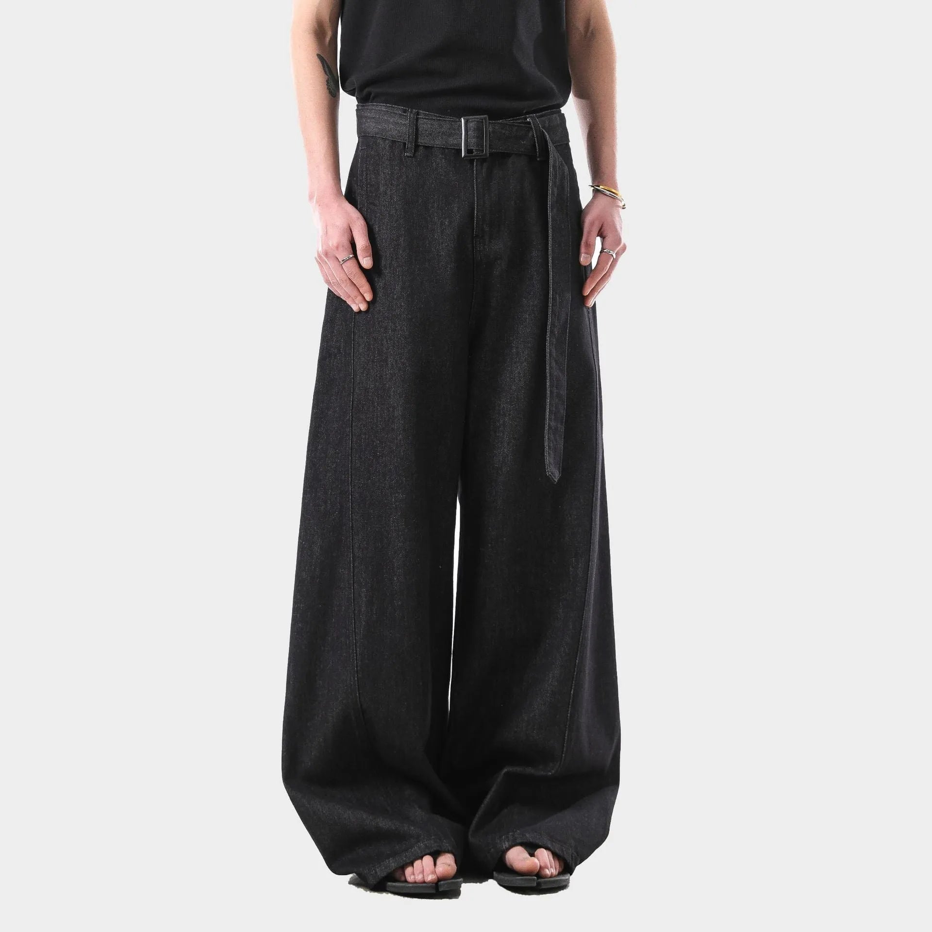 Black high waist straight leg jeans with gold details on a model.