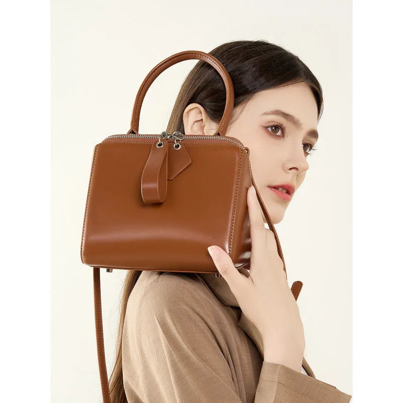 Open grain leather handbag with cowhide lining and welt pocket in black, brown or creamy white