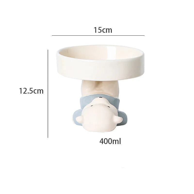 Raised ceramic cat food bowl in an animal theme design on a white background