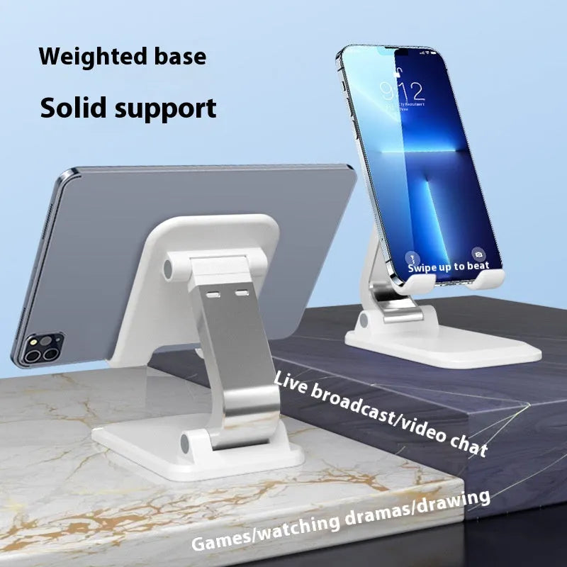 Foldable aluminium alloy phone holder in black on a wooden desk with a smartphone propped up for viewing