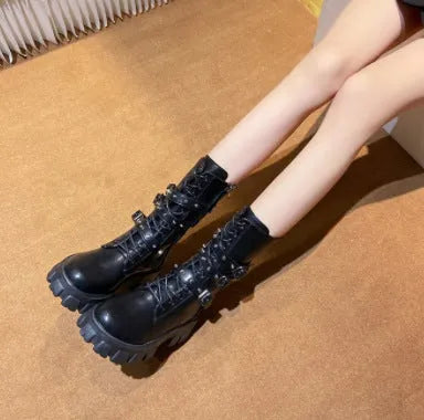 Black women's mid-calf boots with metal buckles and a side zip on a white background.