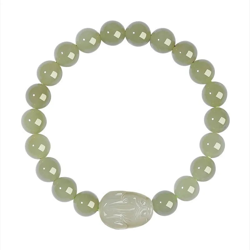 Grey Hetian jade ethnic style bracelet with polished beads on a wrist.