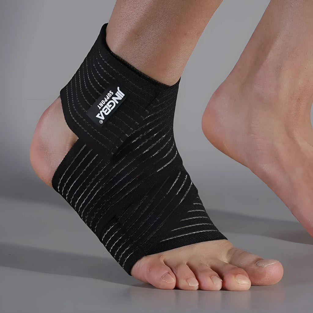 Black adjustable sports ankle support bandage wrapped around a joint
