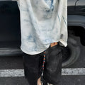 Men's loose-fit short-sleeve T-shirt with distressed print and tie-dye pattern on grey fabric.