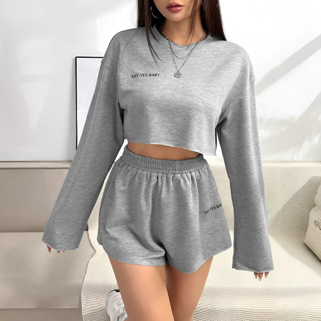 Grey women's long-sleeved T-shirt and matching shorts polyester suit set laid flat.