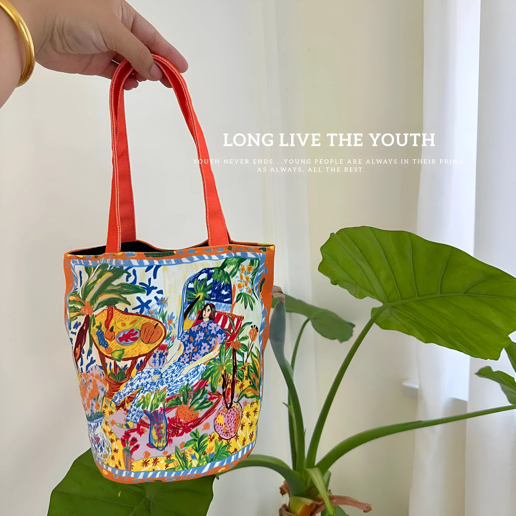 Orange canvas bucket handbag with double shoulder straps and printed letter design