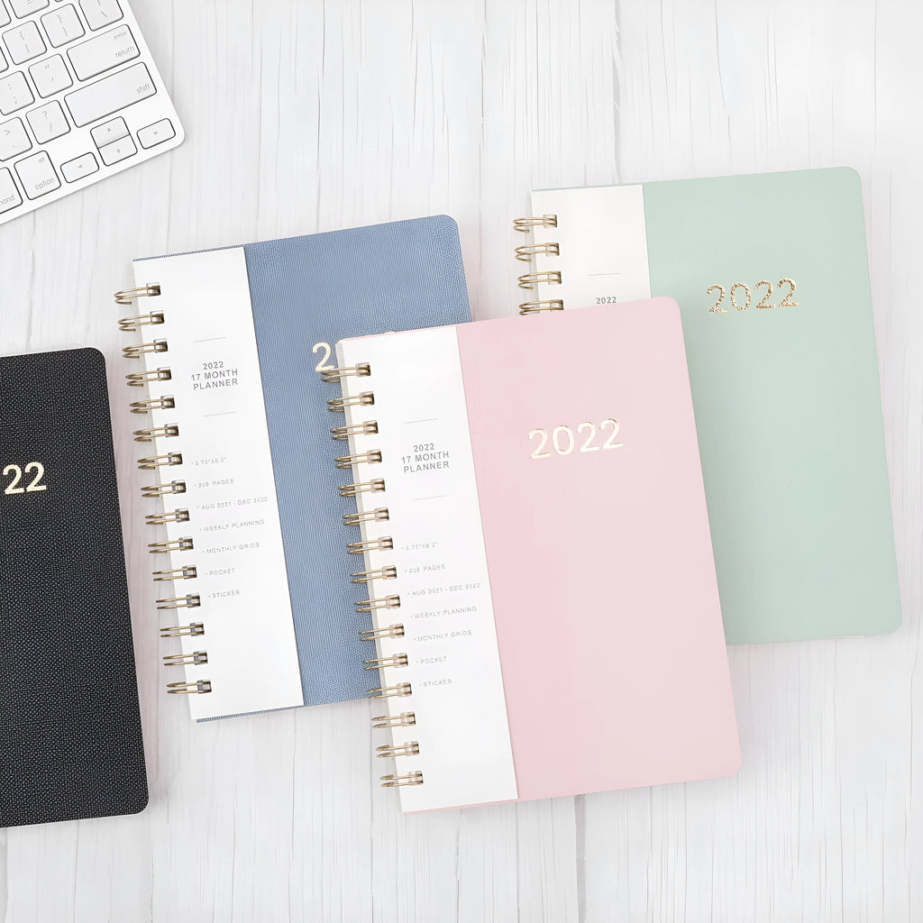 Green and blue 17-month 2022 student planner notebook with coil binding and pockets
