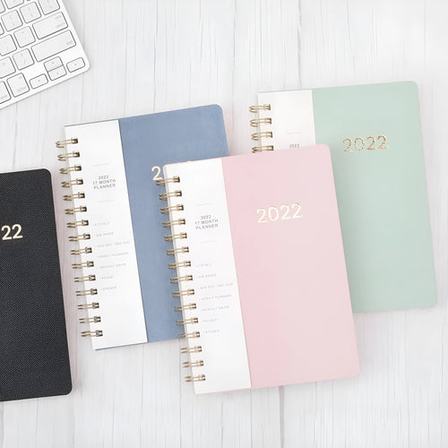 Green and blue 17-month 2022 student planner notebook with coil binding and pockets