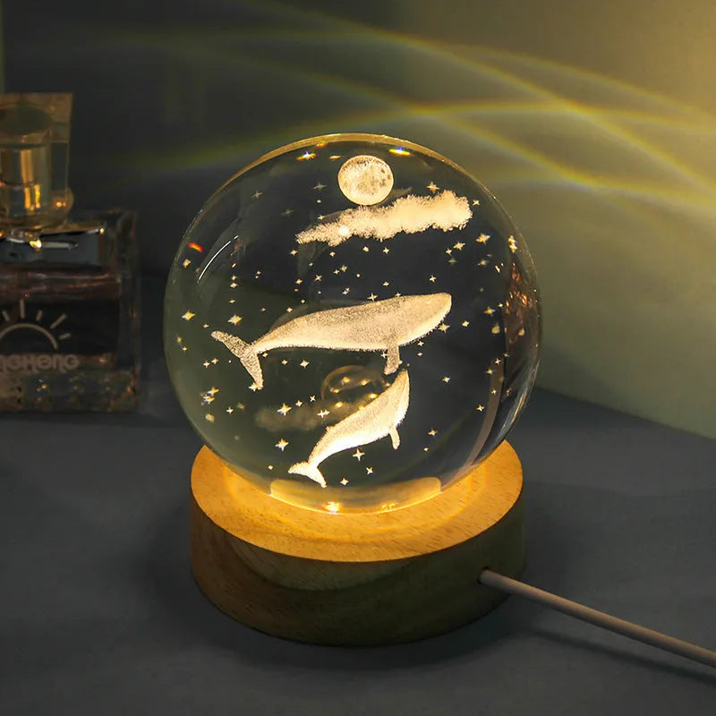 Transparent crystal ball night lamp with 3D carved jellyfish design, on a round base with USB cable.
