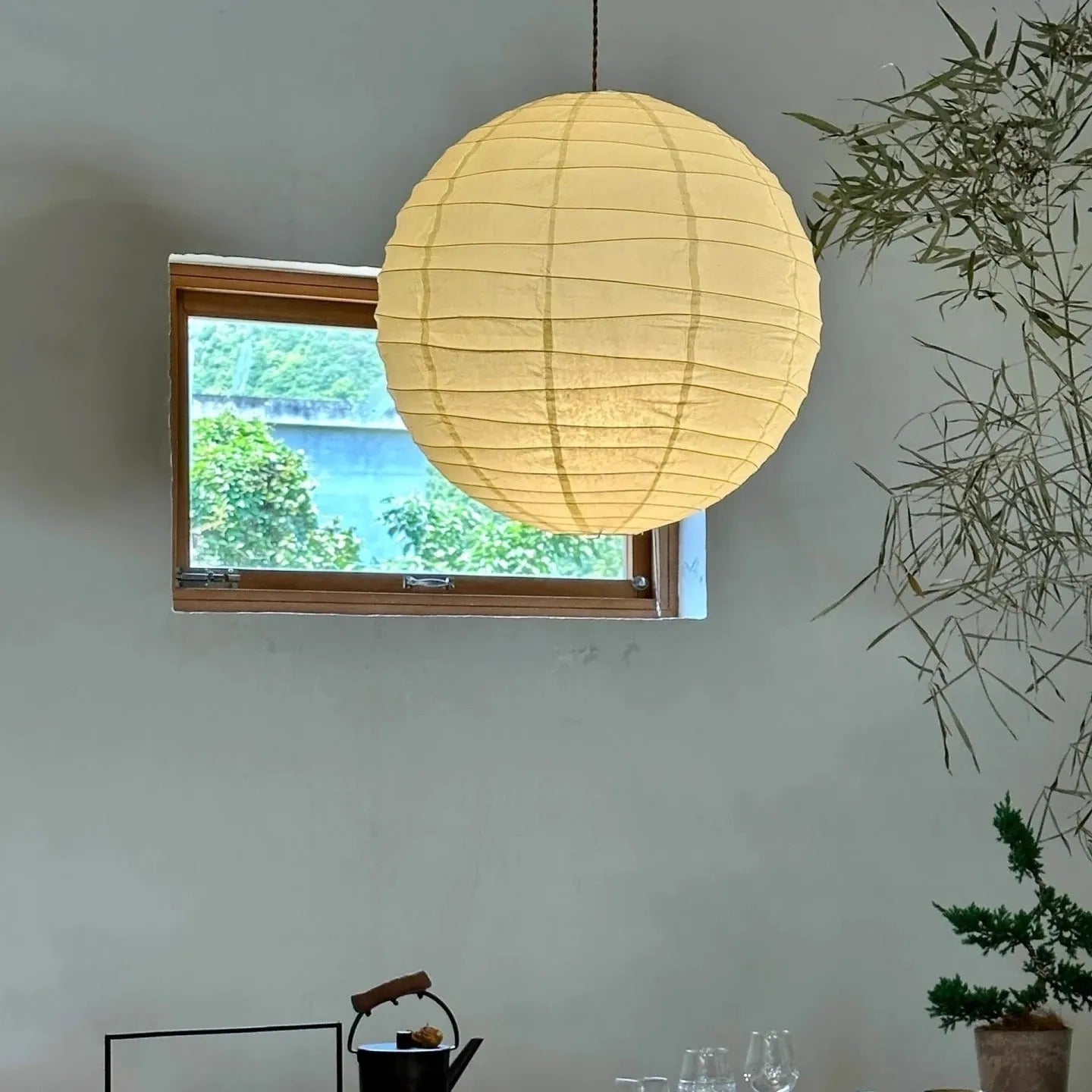 Japanese rice paper chandelier in living room setting with soft ambient lighting