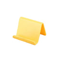 Plastic mobile phone stand in irregular shape on a desk, 6x4.5cm, in blue colour