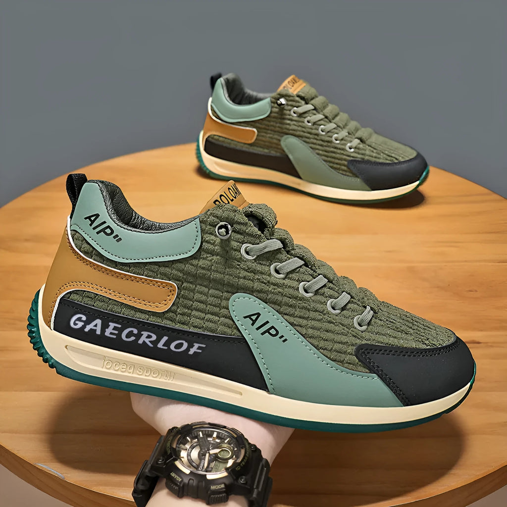 Men's green and grey running shoes with mesh upper and lace-up closure on neutral background