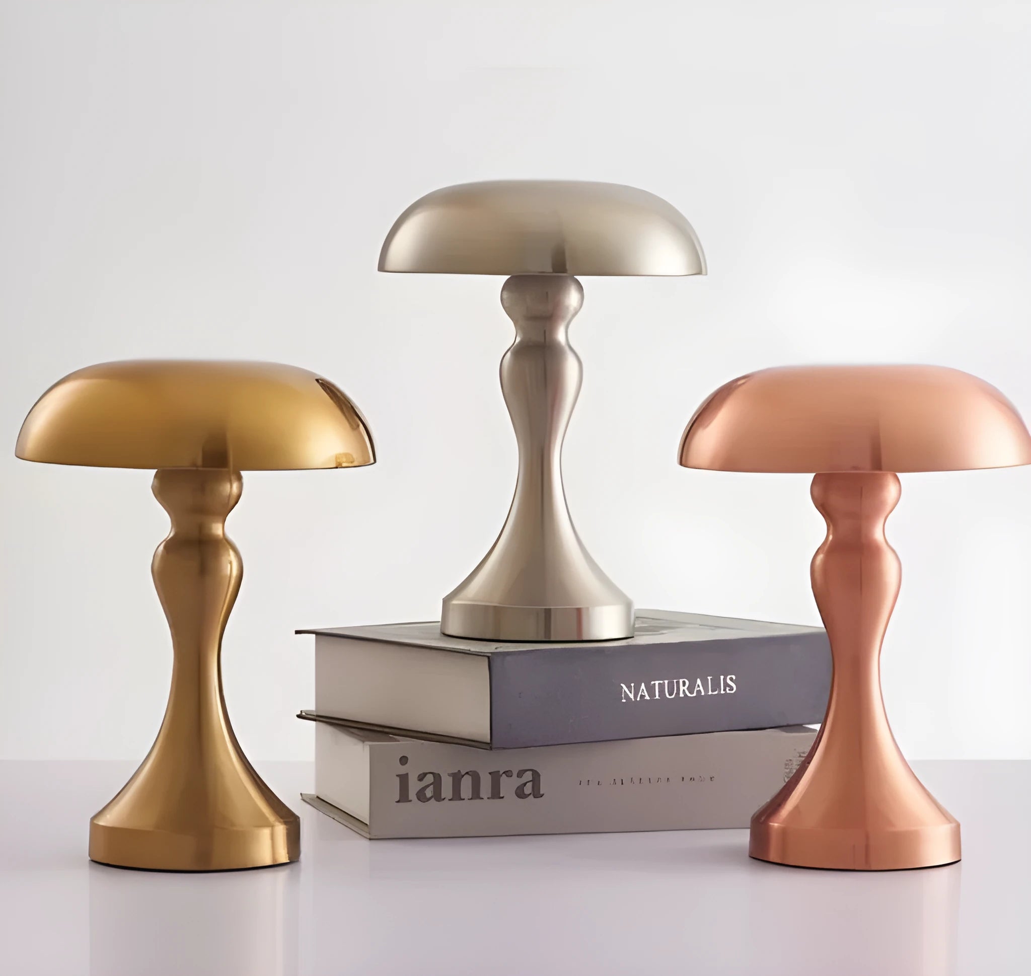 Bronze metallic touch-control LED desk lamp showing three light colour settings on a desk