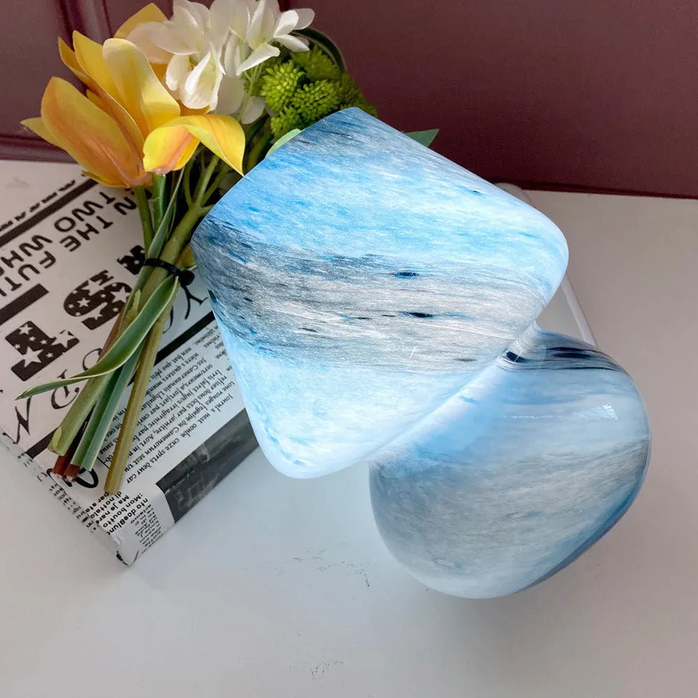 Handmade glass mushroom table lamp in Earth colour finish on a bedside table, showing its compact 15x19cm size