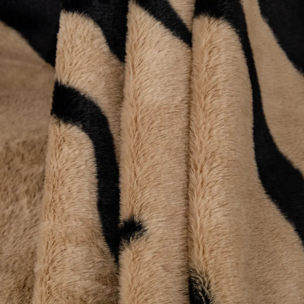 Zebra pattern flannel sofa cover in caramel colour on grey sofa, showing thickened non-slip construction.