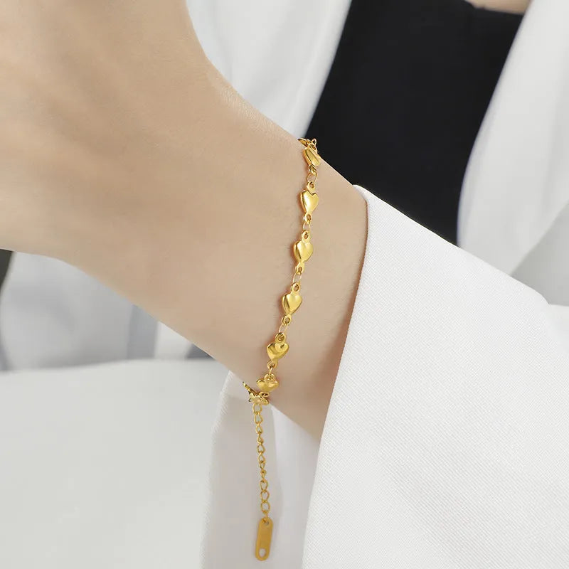 Titanium steel gold chain heart bracelet electroplated colour for women on white background