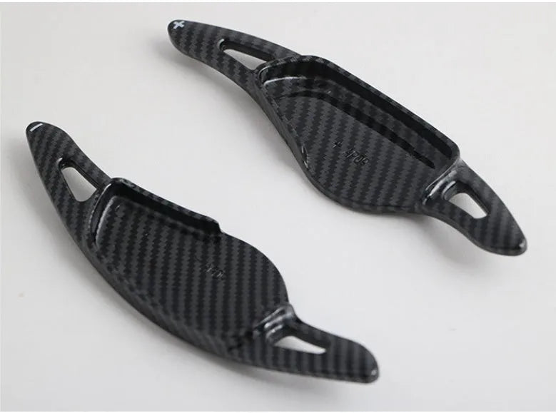 Steering wheel paddle shifters in carbon fibre black finish for manual gear control enhancement