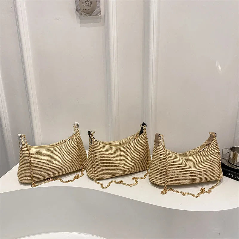 Khaki woven straw crossbody handbag with square shape and crossbody strap.
