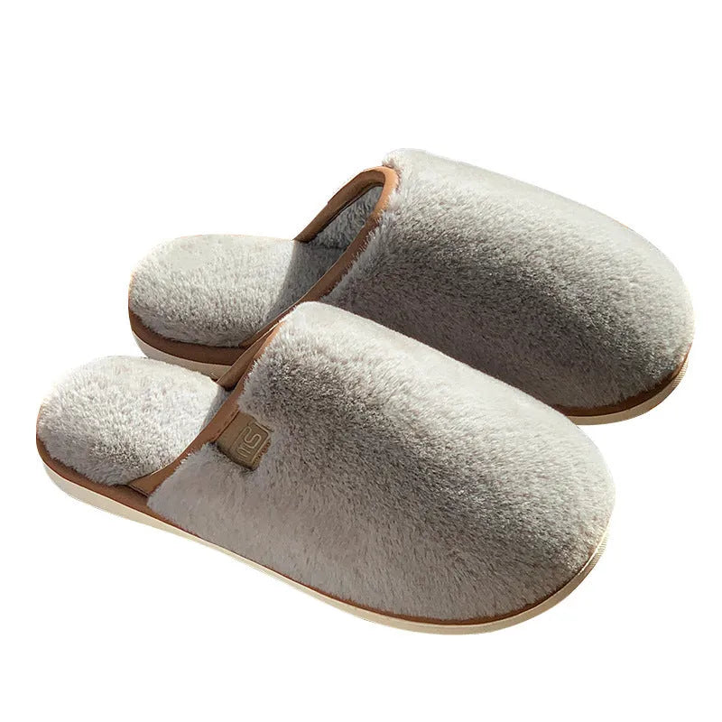 Pair of solid-colour plush house slippers with car stitching detail on the PVC upper.