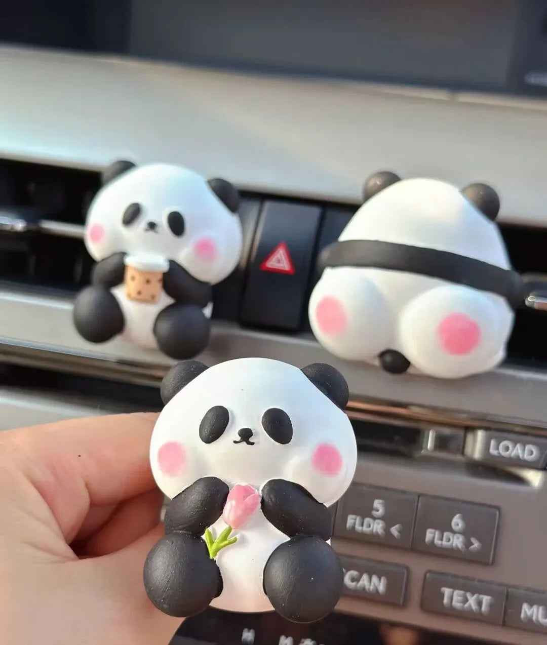 Cute panda-shaped car vent clip air freshener in three character designs: back, holding flower, and milk tea panda.