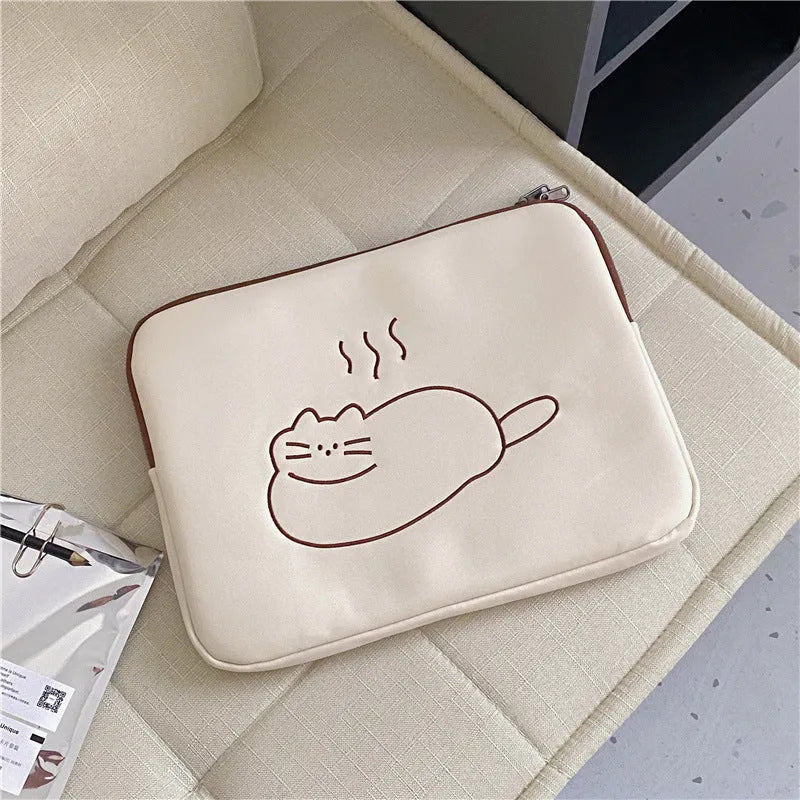 Embroidered fat cat design on a navy blue nylon tablet protective sleeve with a black zipper.
