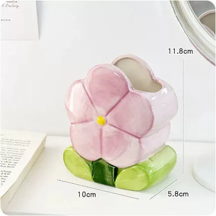 Ceramic pen holder storage box with floral pattern decoration on desktop
