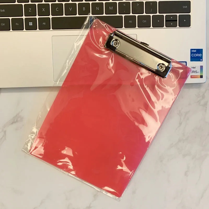 Clear plastic A4 plate holder with metal clip showing document inside, available in blue, green, red and white colours