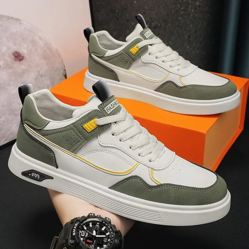 Men's low-top canvas shoes in grey with leather stitching detail on a white background