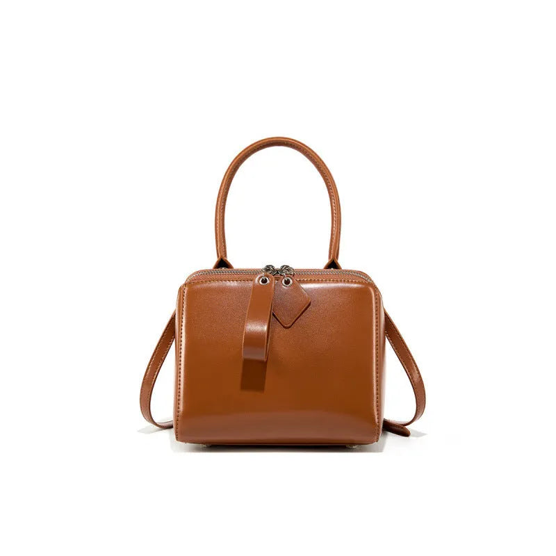 Open grain leather handbag with cowhide lining and welt pocket in black, brown or creamy white