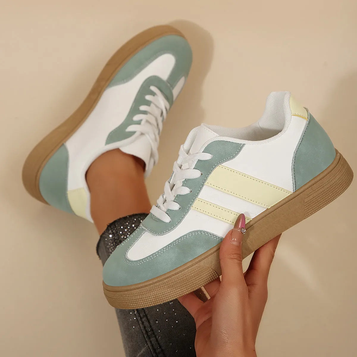 Green women's low-top retro sports shoes with cross straps and a flat rubber sole.