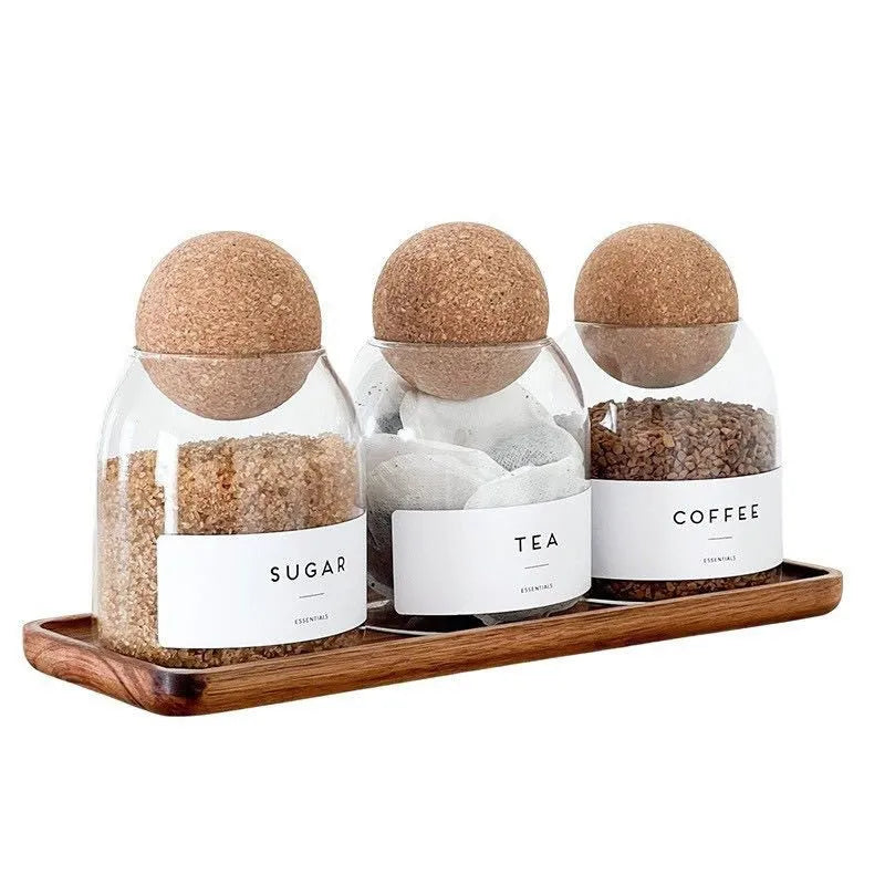Three transparent glass spherical food storage tanks arranged on a shelf with modern simple design