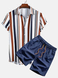 Man wearing a grey digital print short sleeve cardigan and matching shorts from a casual lounge suit set.