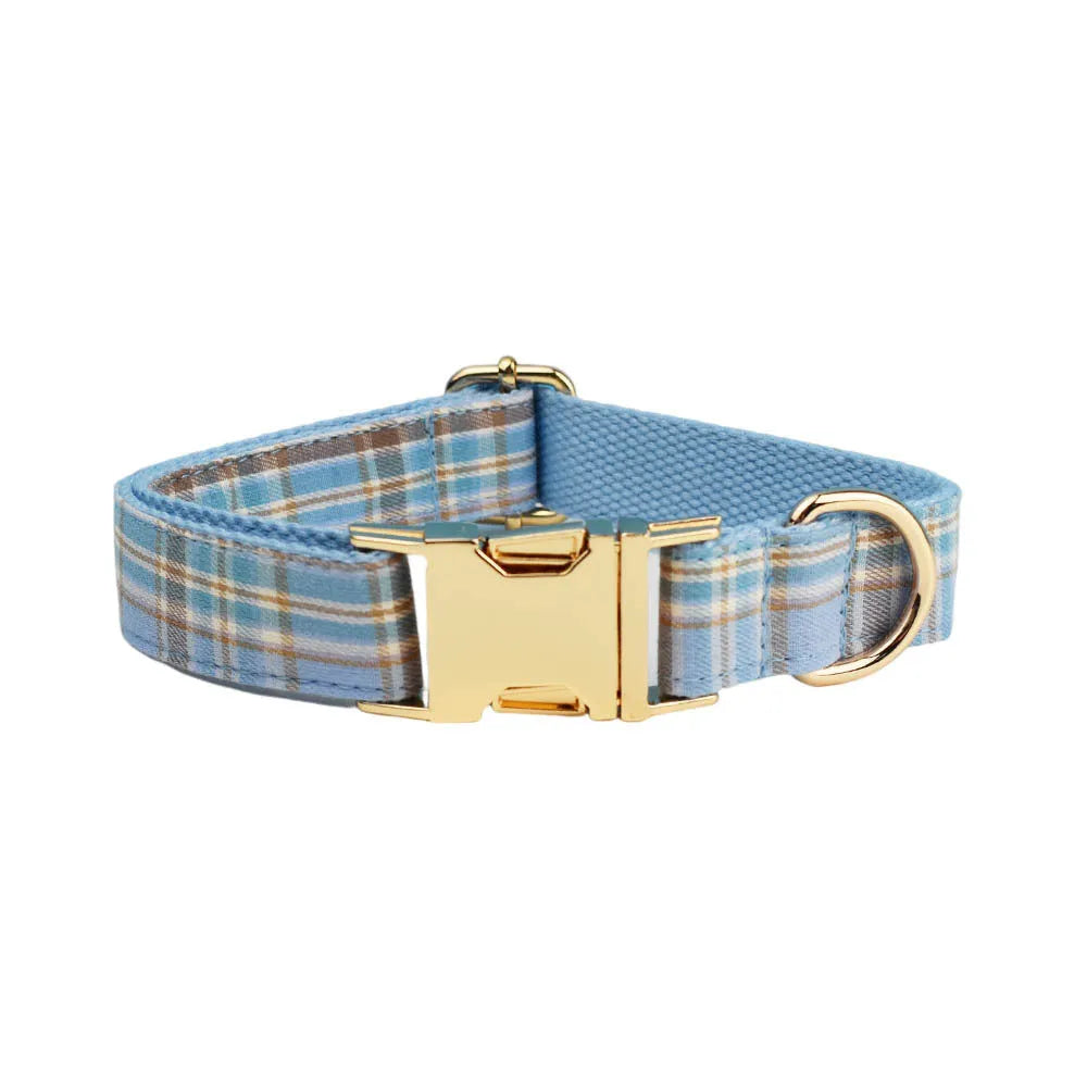 Sky blue grid forest pattern dog collar, leash, bow, and vest four-piece set on white background