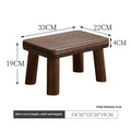 Solid wood household stool with distressed finish, shown as a changing stool or footrest.