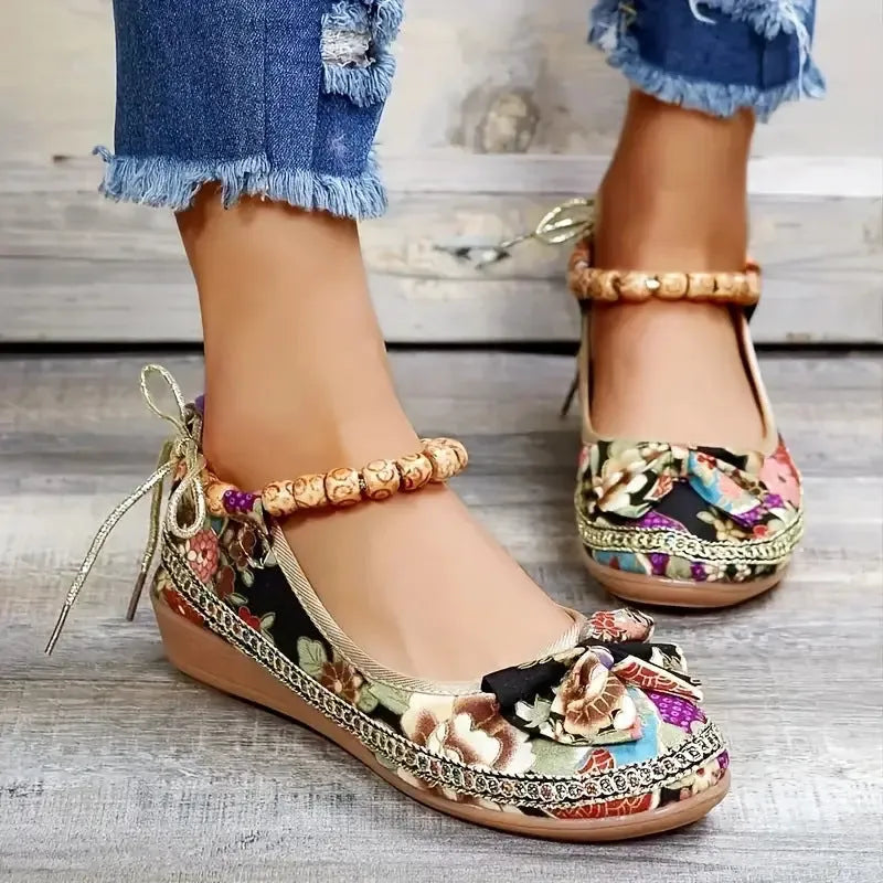 Women's black ethnic style platform sandals with elastic band and round toe on a cloth upper.
