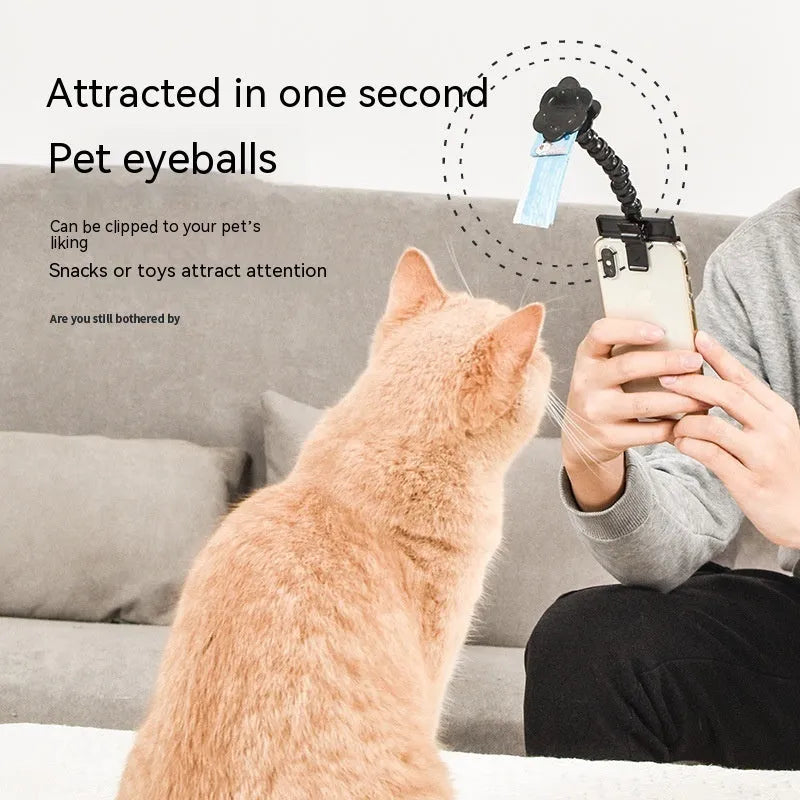 Pet photography tool clip for phone holding a treat to attract cat or dog attention, black plastic