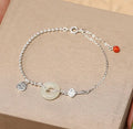Women's silver bracelet with Hetian jade and geometric peace buckle design in Chinese style